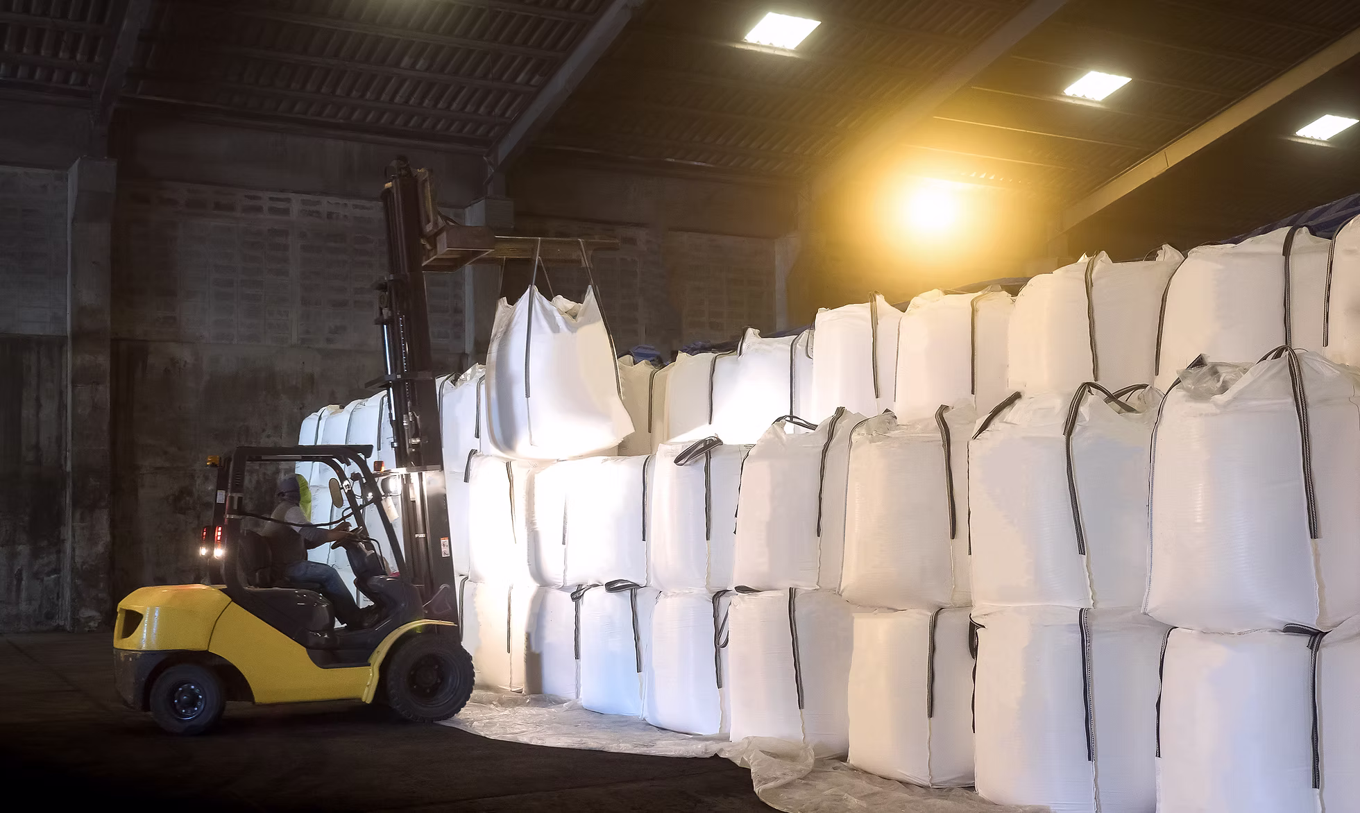 Forklift stacking jumbo bags of cassava product inside the PSAgrimex JSC warehouse